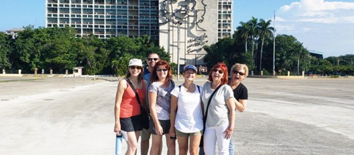 A group of travelers visiting the Plaza de la Revolucion in Havana