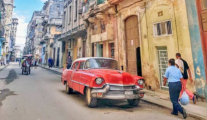 A red classic American 50s car in Central Havana