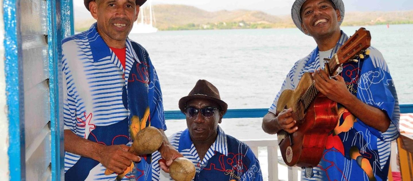 a trio of smiling musicians