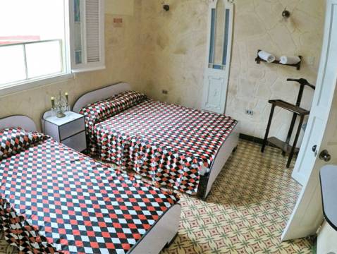 An image of a simple guesthouse room in Havana, Cuba.