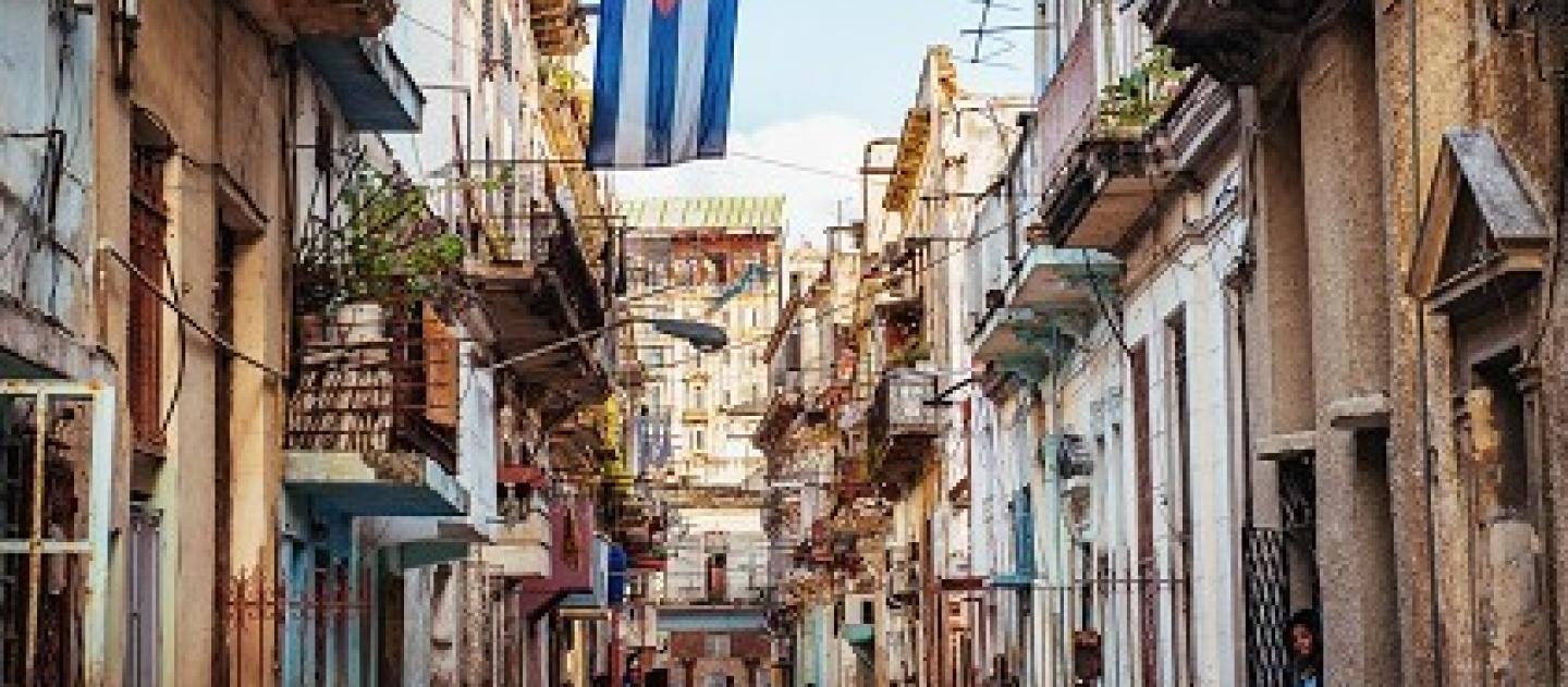Cuban flag over a narrow street in Old Havana