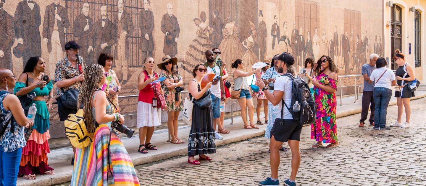 Group with tour leader by Historic Wall Mural