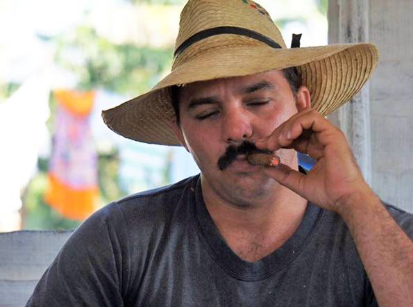  A Cuban farmer smokes a cigar