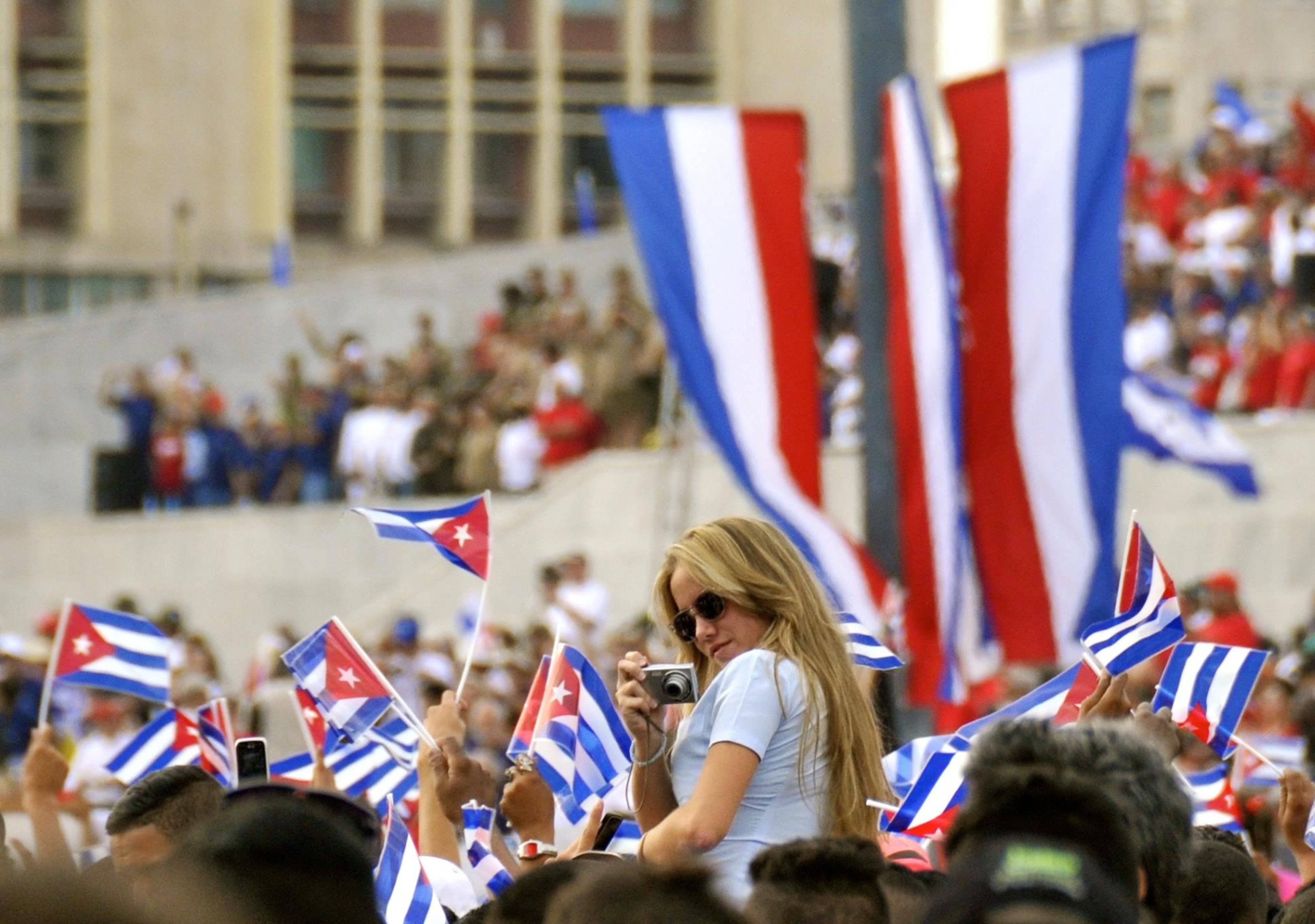 There is no shortage of national pride and flag waving at the parade A girls gets a shoulder ride during the May Day Parade in Havana