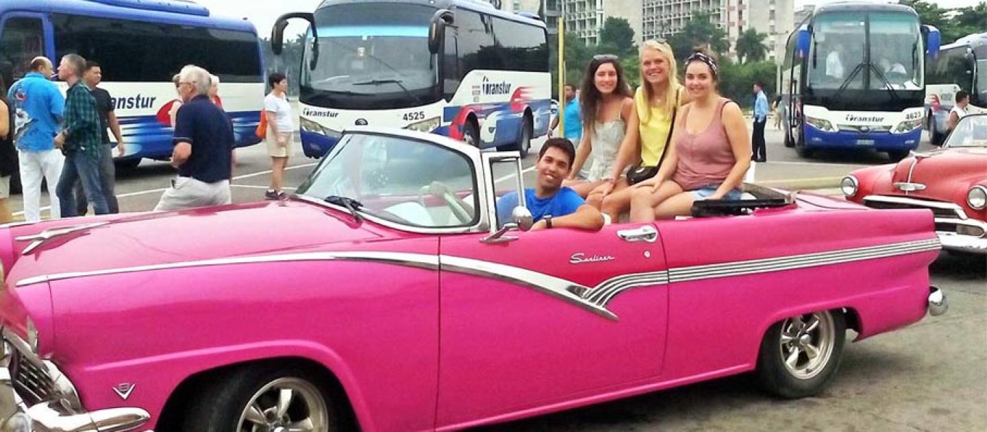 Tour guide Armando Lee Socarras with 3 happy customers in his Ford Fairline '56 that he and his father painted pink only recently.