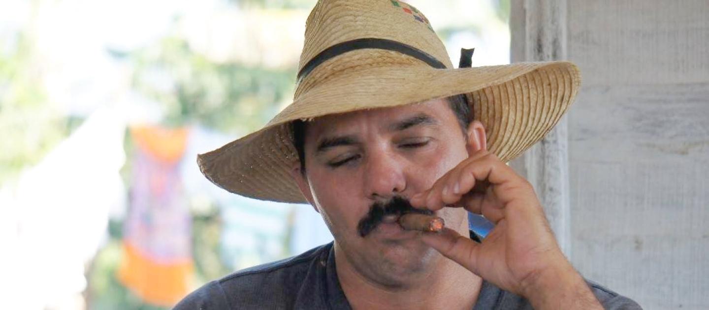 a Cuban farmer smokes a cigar