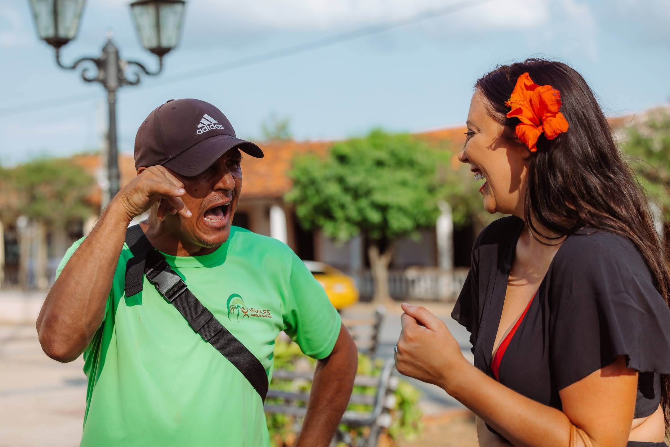 Woman with red flower talking to Vinales local Woman with red flower talking to Vinales local